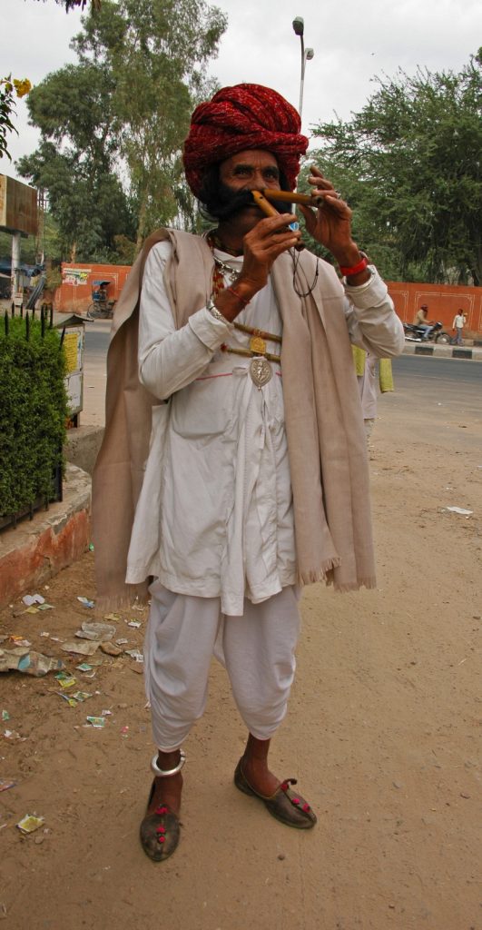 Jaipur - Street musician playing on flute with his nose