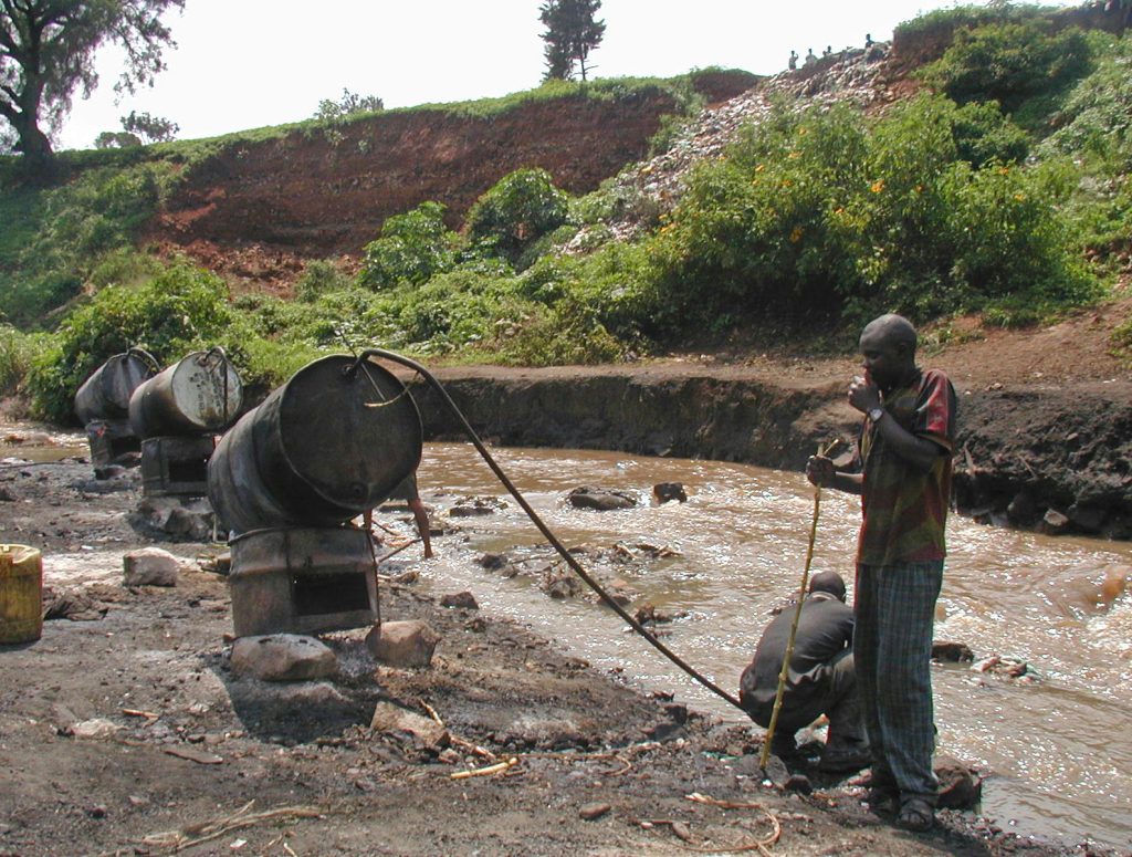 Chang'aa (moonshine) factory byt the river in the Mathare Slums, Nairobi. Picture taken in 2003